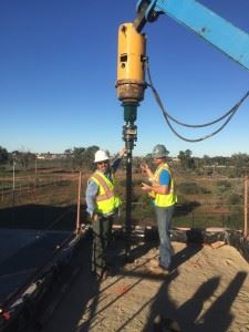 Two construction workers with equipment