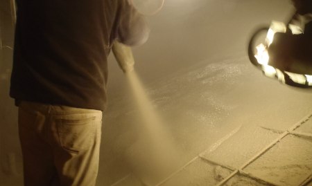 A basement being waterproofed with a membrane applied to the floors.