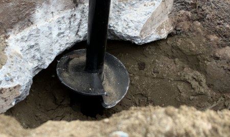 Helical pile visible outside the home