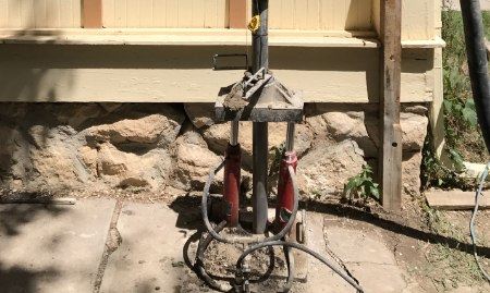 A professional injecting grout or cement into the sinkhole to stabilize the ground.