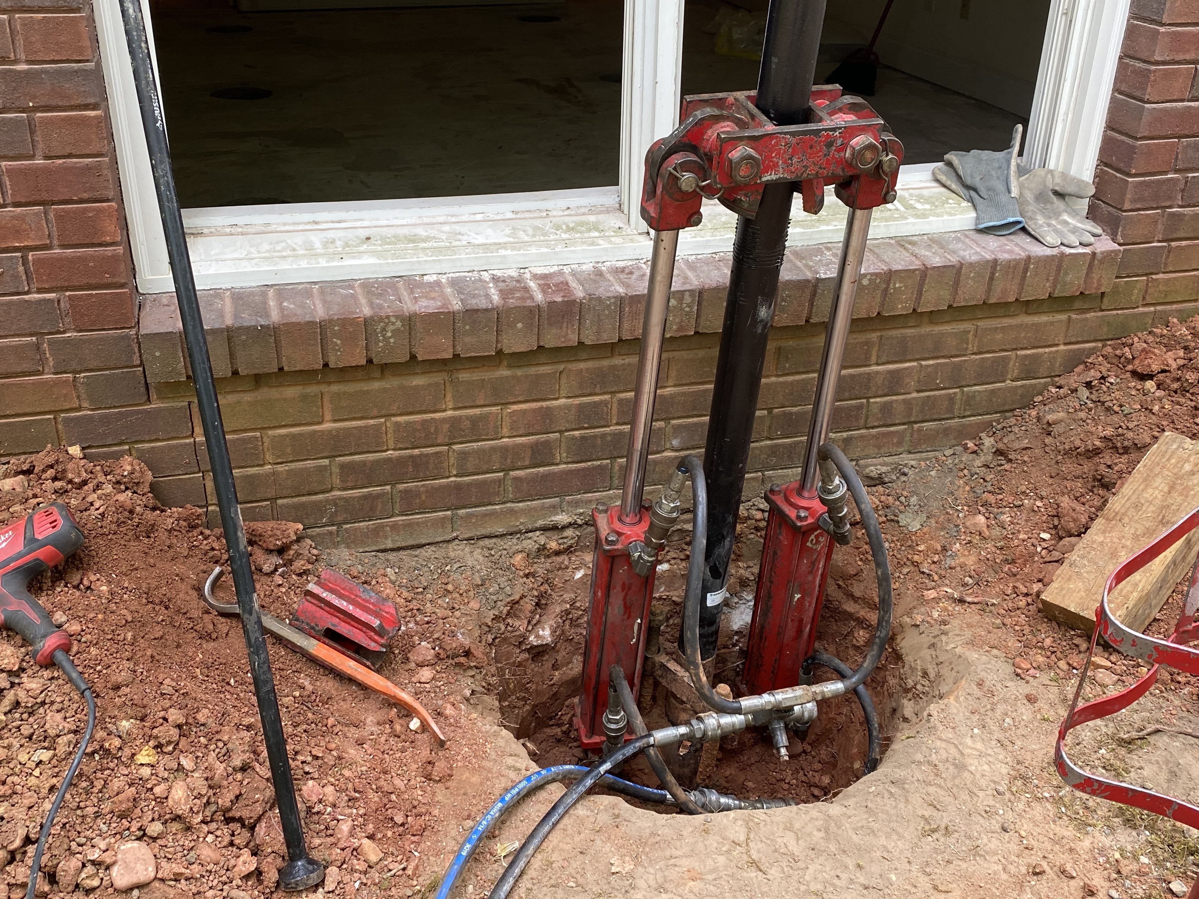 Close-up of a driven pile being installed with a driver.